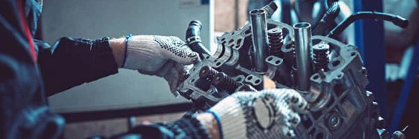 Close up view of a service tech working on a diesel vehicle