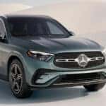 A dark green 2026 Mercedes-Benz GLC SUV parked in sweeping white dunes.