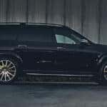 black 2026 Mercedes-Benz GLS SUV parked against a dark, textured concrete wall.