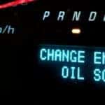 close-up view of a dashboard with the message change engine oil soon displayed