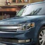 steel blue ford flex parked in a driveway of a nice home